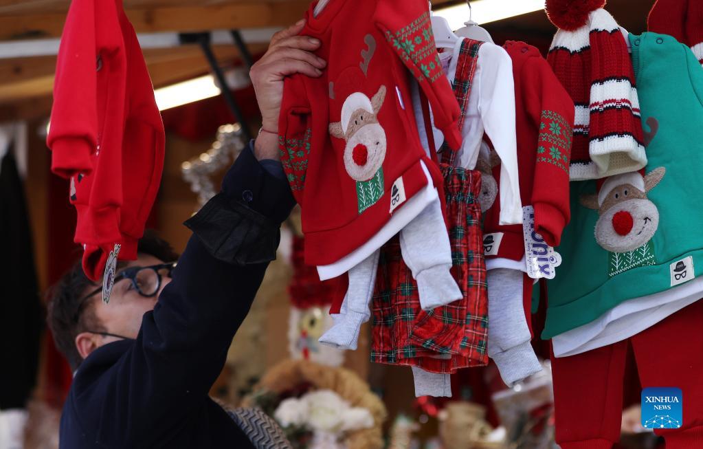 People enjoy themselves at Christmas market in Paris