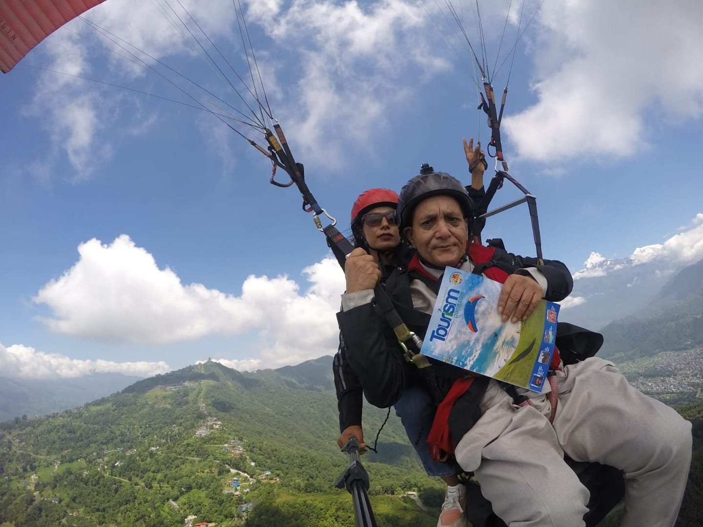 Minister launches magazine by paragliding