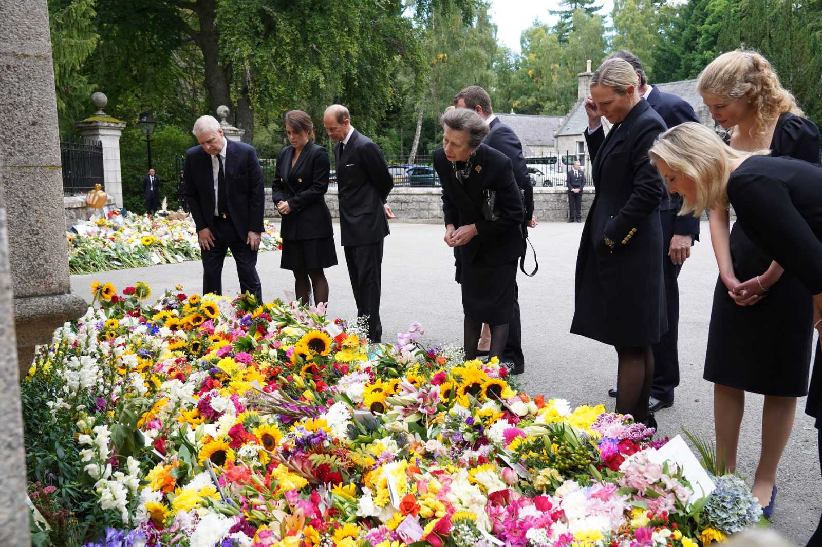 Members of the Royal Family view the floral tribute