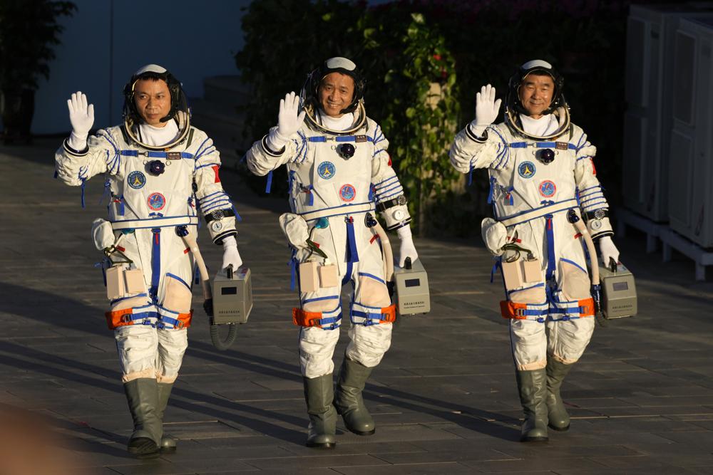 China launches first three-man crew to new space station