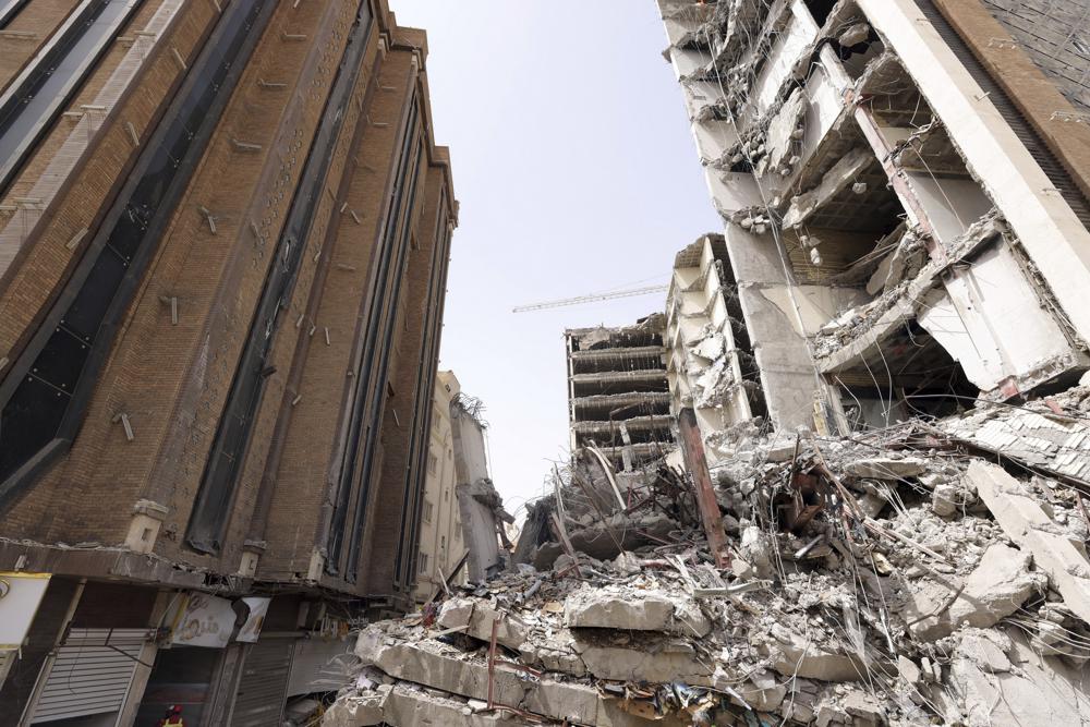 Crowd confronts cleric at Iran tower collapse that killed 31