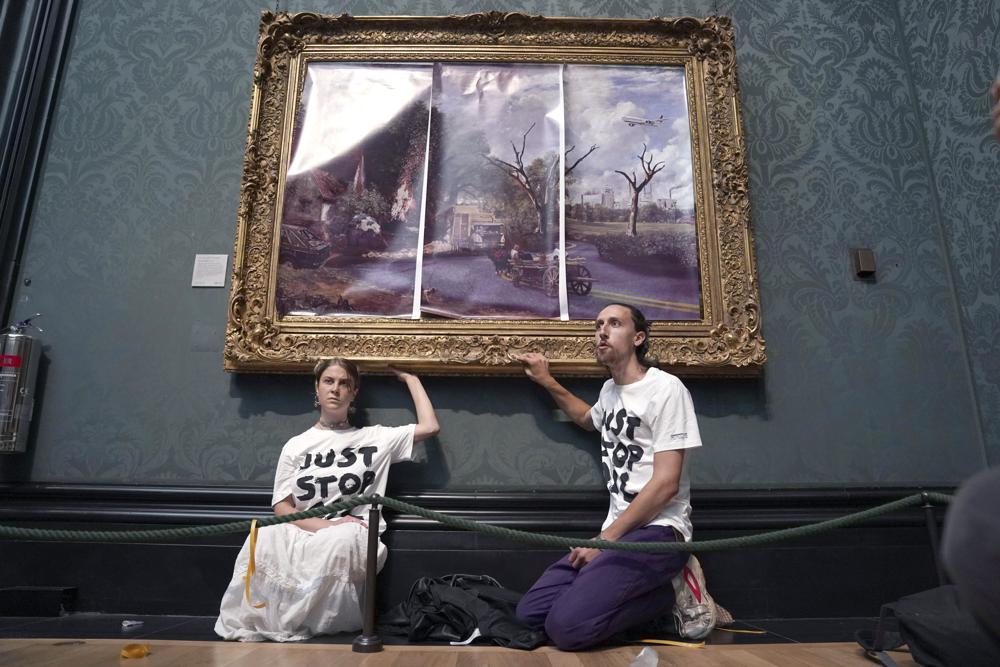 UK climate protesters glue themselves to Constable frame