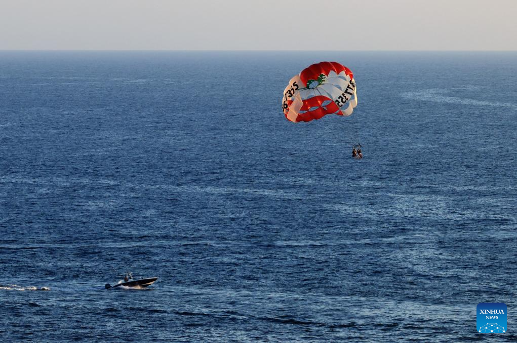 Tourists paraglide along coast of Beirut, Lebanon