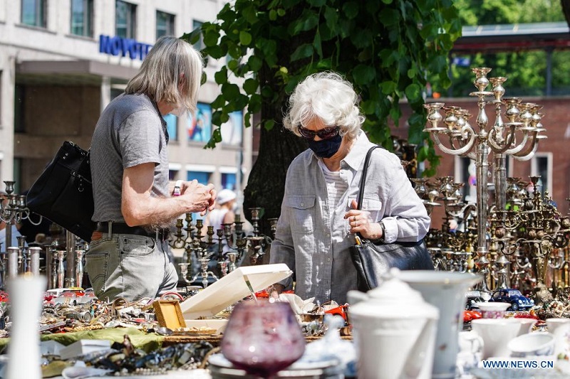 People visit flea market in Berlin