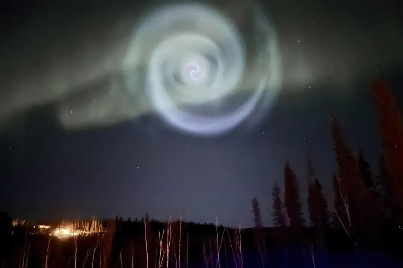 Odd spiral appears amid northern lights