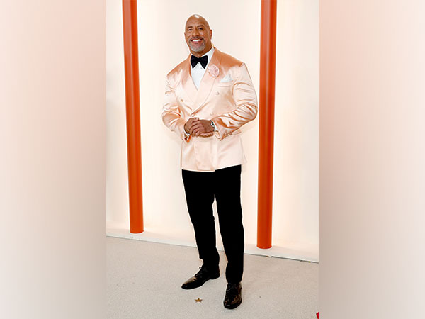 Dwayne looks dapper in metallic pink suit