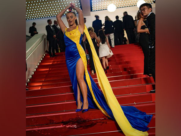 Woman pours fake blood at Cannes red carpet