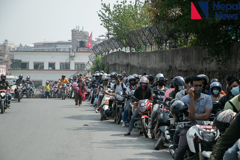 People waiting outside petrol pumps