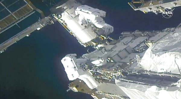 Spacewalking astronauts prep station for new solar wings