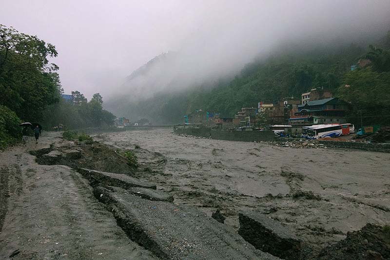 Rain obstructs road linked to China