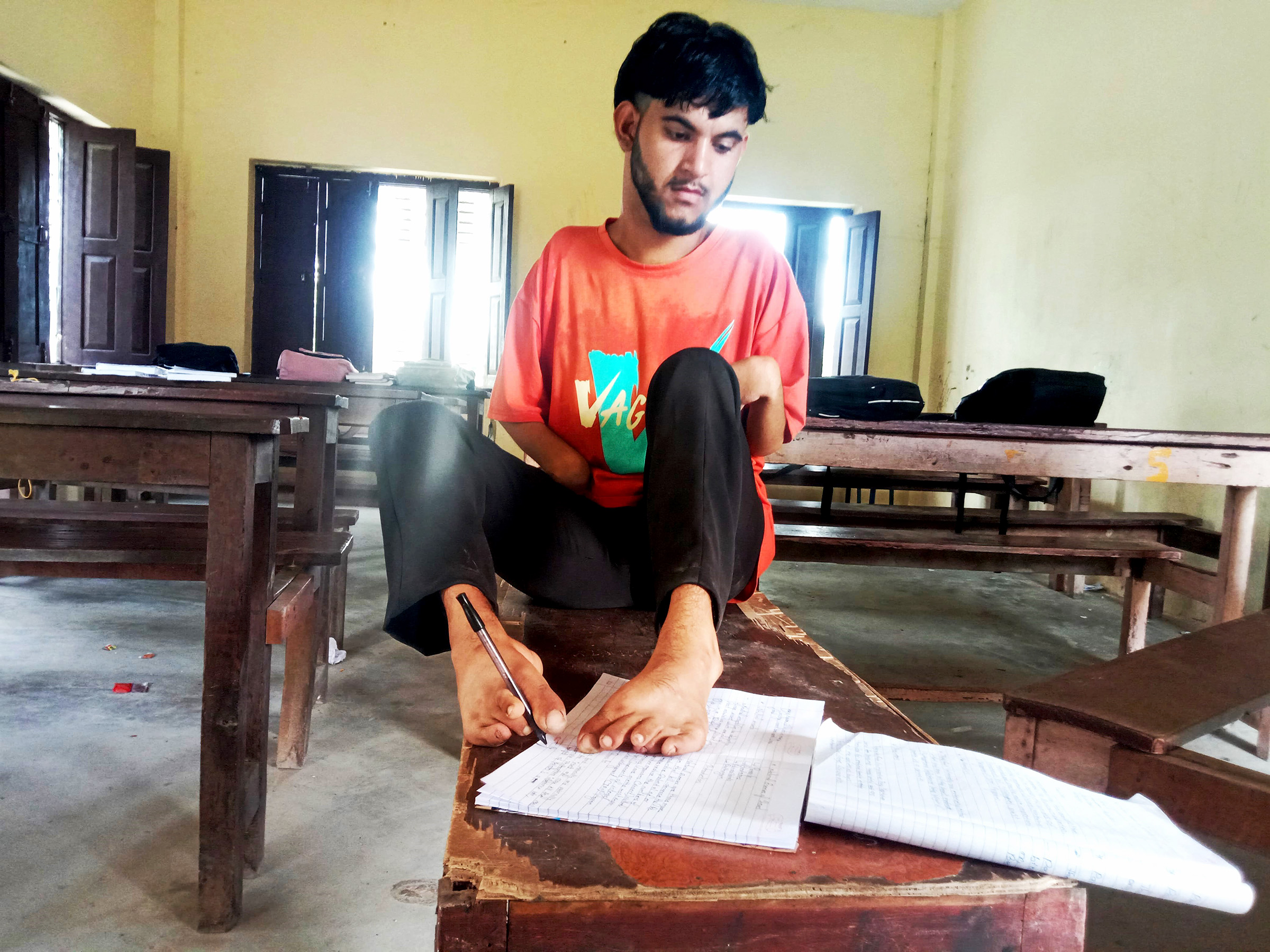 Student who have passed SEE by writing with foot