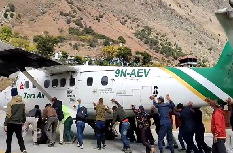 Passengers push airplane off runway