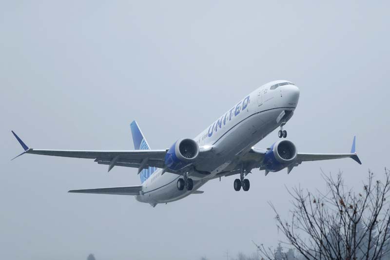 Man accused of trying to open airplane door during flight