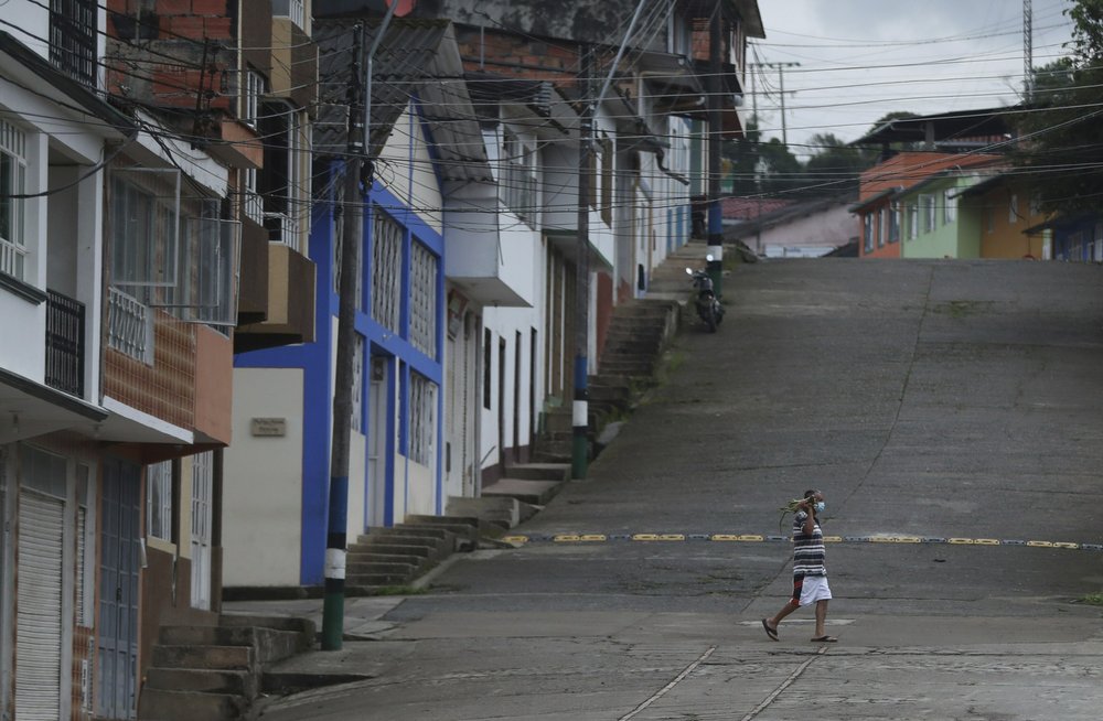 Colombian town uses discipline, speakers to stay virus-free