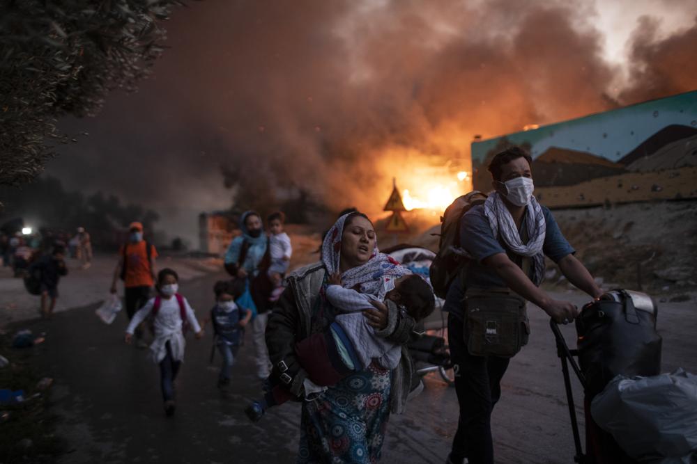 Aid groups decry migrant camp conditions a year after fire