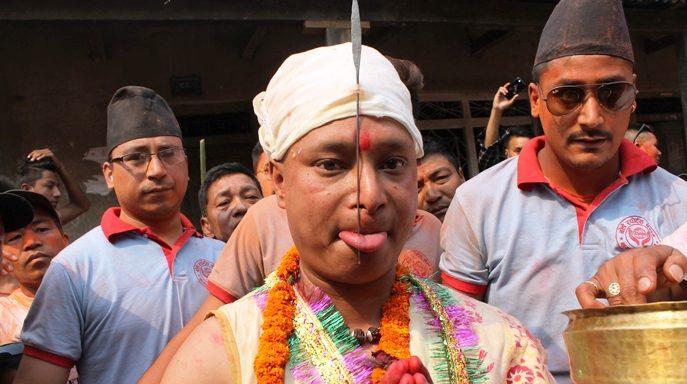 Sujan, 27, pierces tongue on Bisket Jatra