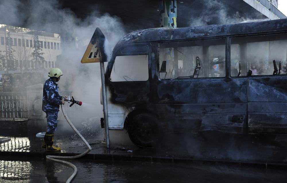 Roadside bombs hit military bus in Syrian capital, kill 14