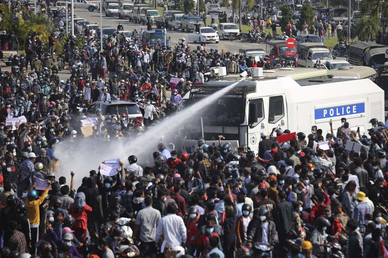 Water cannon fired at protesters as crowds swell in Myanmar