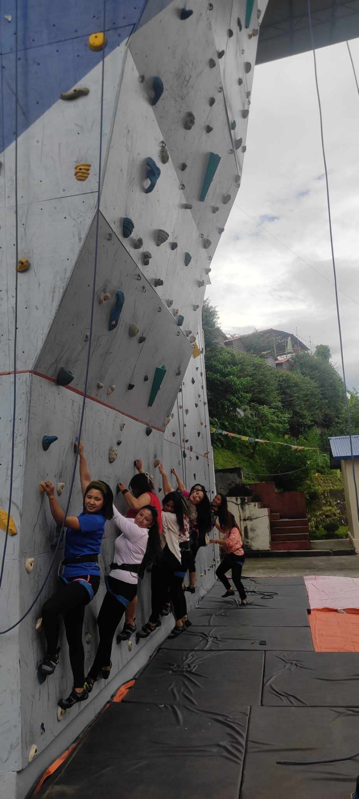 Women doing wall climbing in Teej Festival